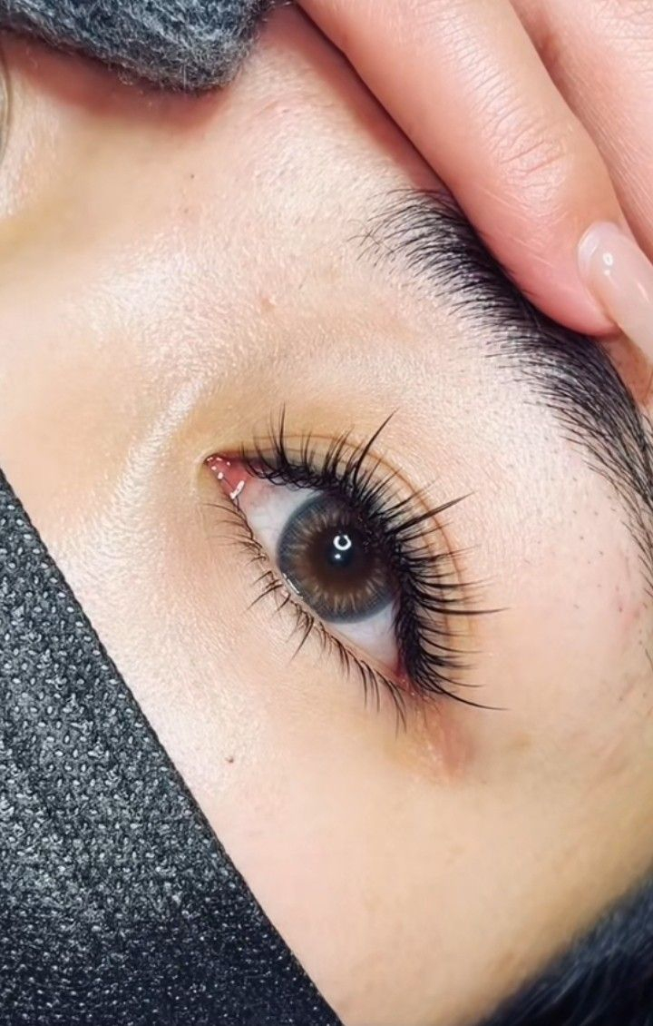 Soft natural hybrid eyelash extensions with light wispy outer corner lift