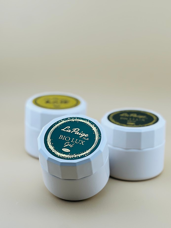 White jars of La Paige Nails Bio Lux Gel with gold emblem packaging