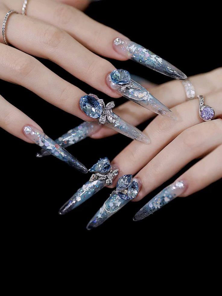 Lavender chrome stiletto nails with large pink gemstone and crystal rhinestones