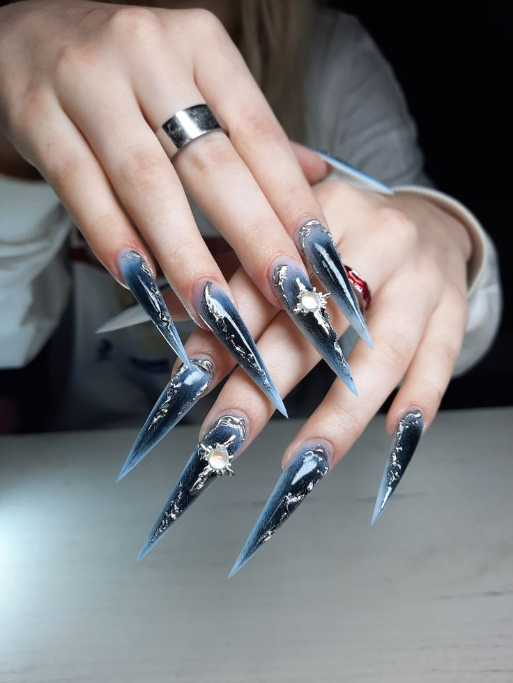 Clear blue glitter stiletto nails with sapphire bow crystals and sequins