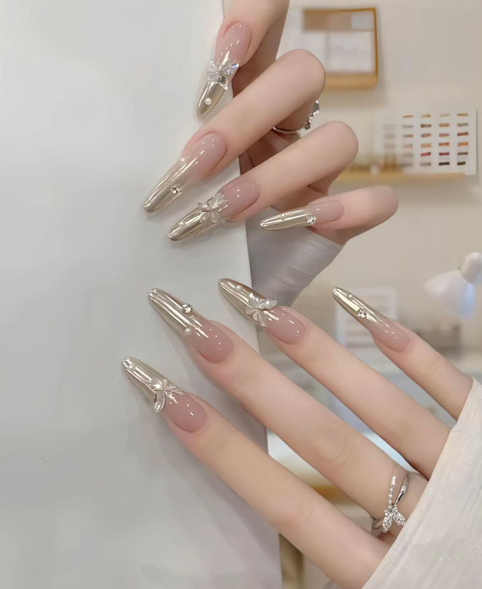 Long almond chrome nails Sherway Gardens Mall with silver ombré and 3D crystal butterfly accents